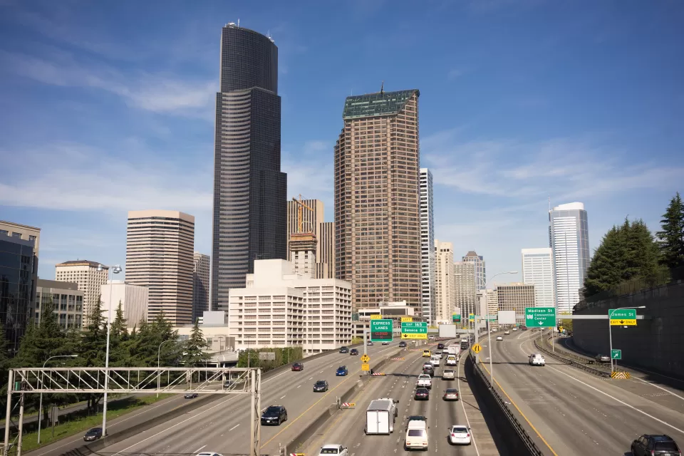 View of Interstate 5 with light traffic and downtown Seattle skyline in background